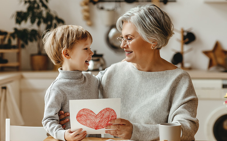 woman and child holding greeting card together